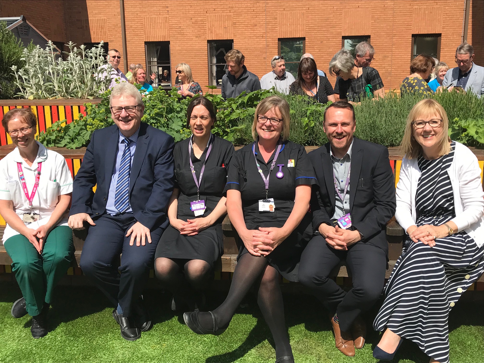 Staff enjoying the sunshine at the opening of the garden