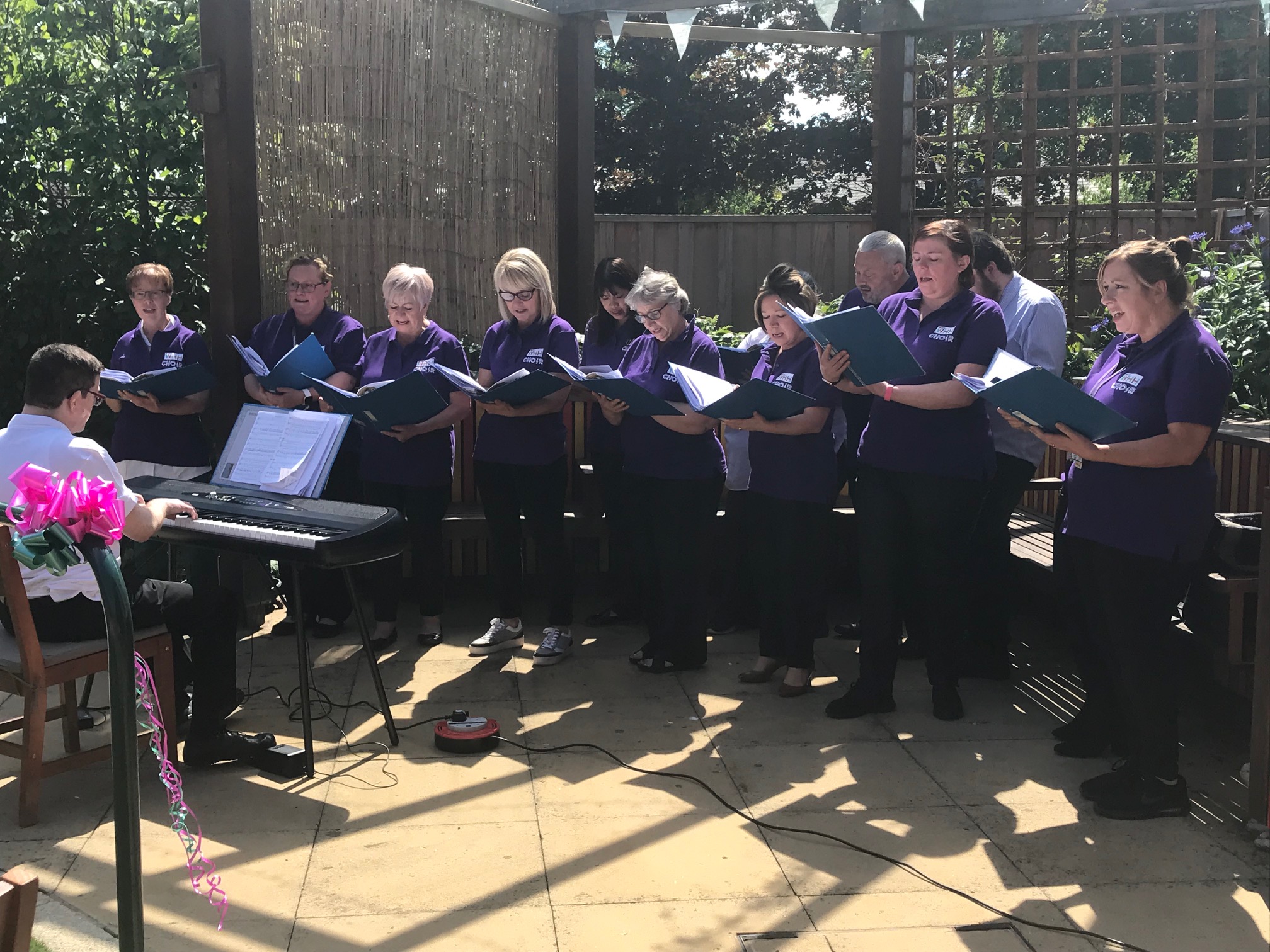 WHH Choir performing in the sunshine at the opening of the Forget Me Not Garden