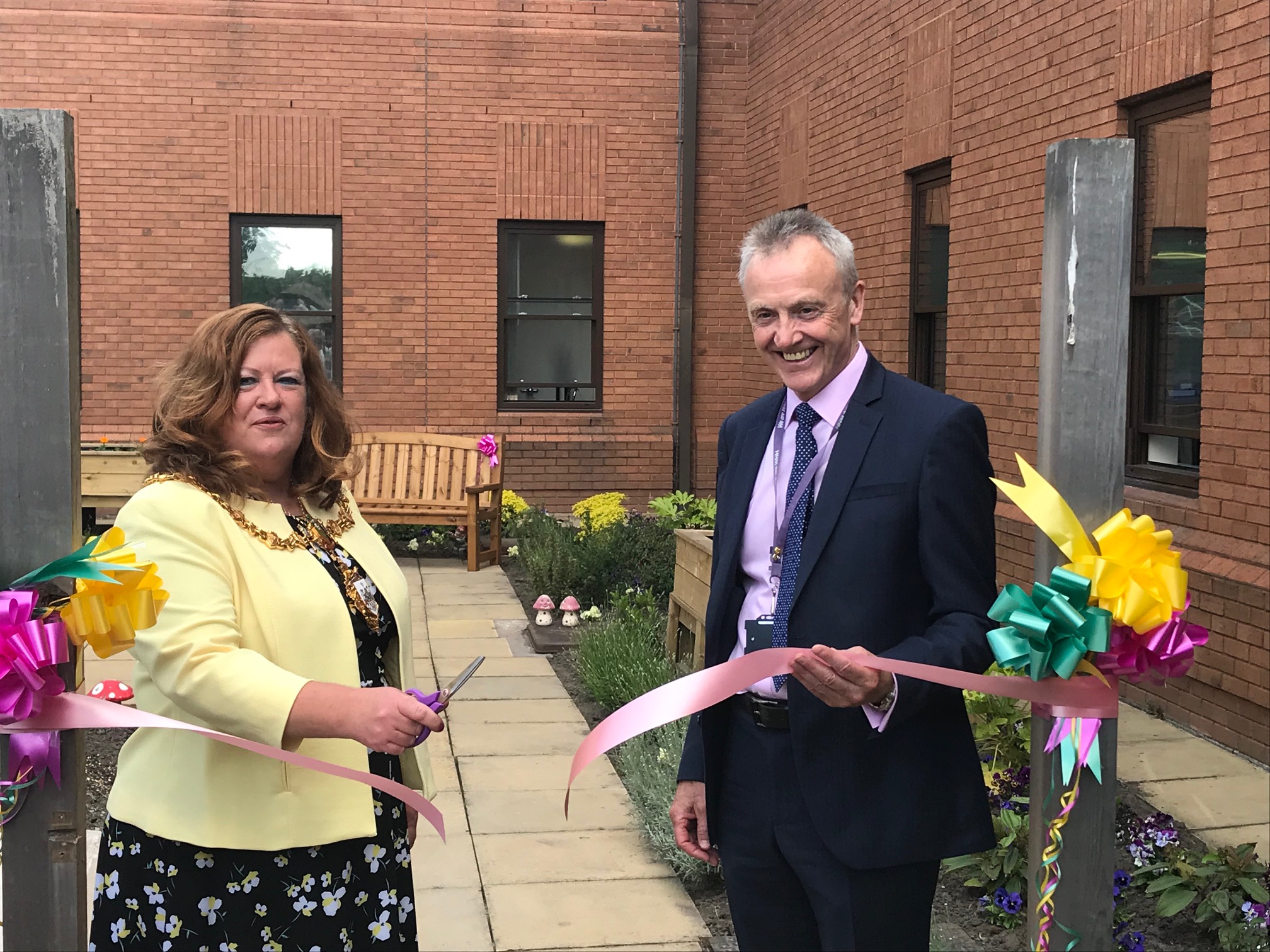 Mayor of Warrington, Cllr Wendy Johnson cutting the ribbon of the new garden with Chairman Steve McGuirk